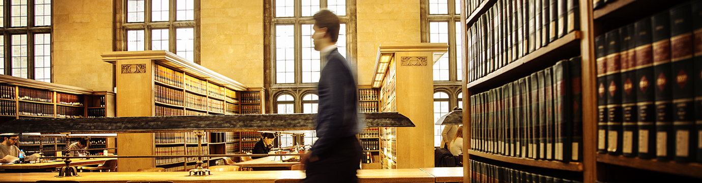 student walking through a library